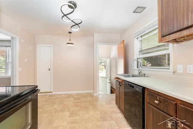 114 E Sugnet Rd, Midland, MI 48642 - kitchen featuring black appliances, light countertops, and pendant lighting