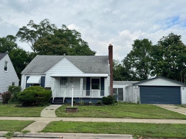 3033 Williams St, Inkster, MI 48141 - bungalow-style home featuring covered porch, a front yard, a chimney, and a garage