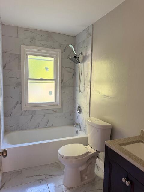 3033 Williams St, Inkster, MI 48141 - bathroom featuring vanity, marble look tile flooring, and  shower combination