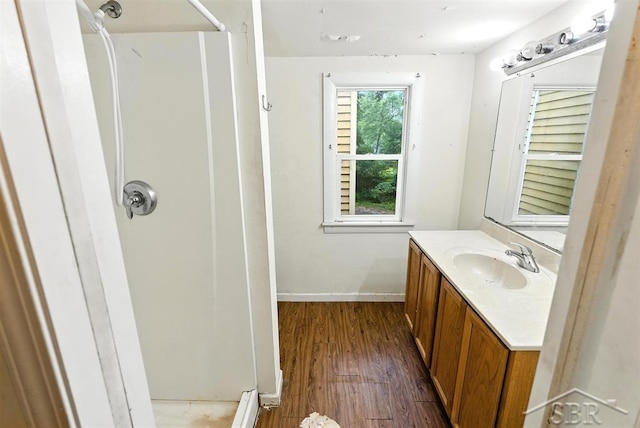 3704 Concord St, Midland, MI 48642 - full bathroom featuring vanity, a shower, and wood finished floors