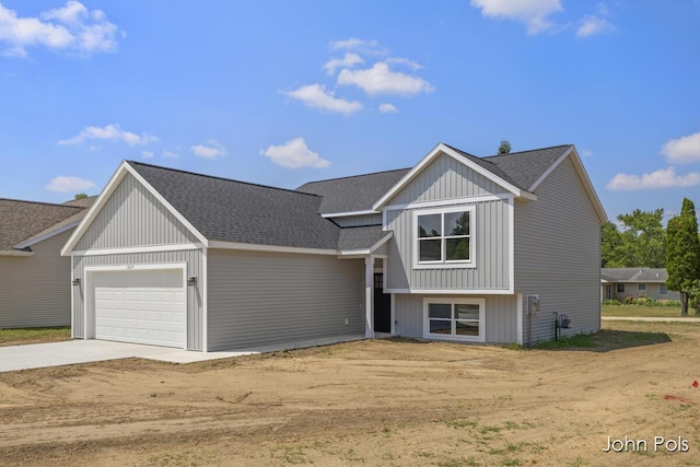 1025 Mechanic St, Big Rapids, MI 49307 - view of front of house with driveway, a garage, and a shingled roof