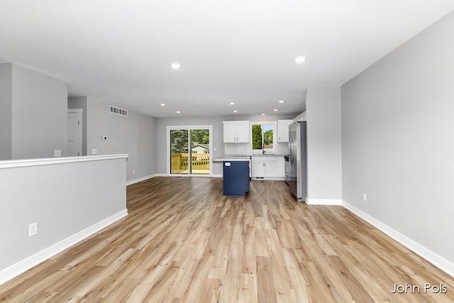 1025 Mechanic St, Big Rapids, MI 49307 - unfurnished living room featuring light wood-type flooring and recessed lighting