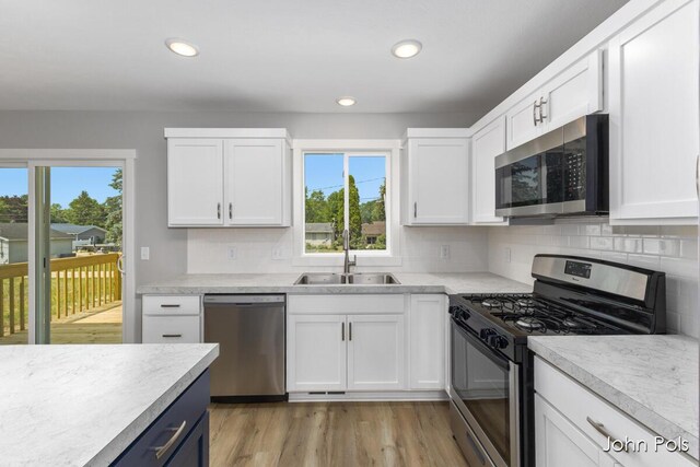 1025 Mechanic St, Big Rapids, MI 49307 - kitchen featuring appliances with stainless steel finishes, plenty of natural light, light countertops, decorative backsplash, and recessed lighting