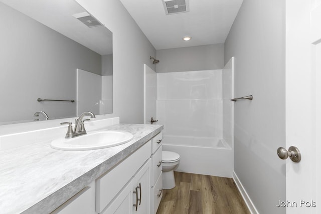 1025 Mechanic St, Big Rapids, MI 49307 - full bathroom featuring vanity, wood finished floors, and shower / bathtub combination