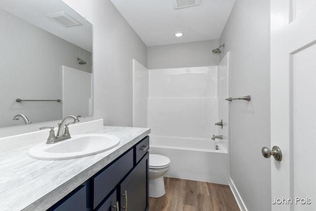 1025 Mechanic St, Big Rapids, MI 49307 - bathroom featuring vanity, shower / bath combination, and wood finished floors
