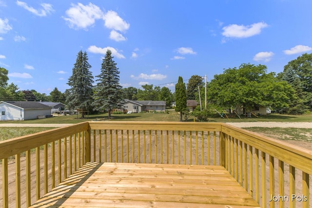 1025 Mechanic St, Big Rapids, MI 49307 - wooden deck with a yard and view of wooded area