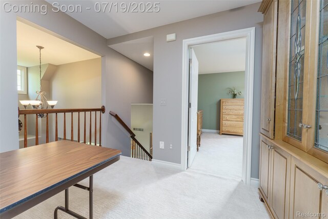 10827 Sparkling Waters Ct, South Lyon, MI 48178 - hall with an upstairs landing, light carpet, recessed lighting, and a chandelier