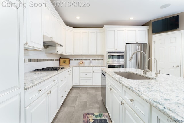 10827 Sparkling Waters Ct, South Lyon, MI 48178 - kitchen with stainless steel appliances, white cabinetry, backsplash, recessed lighting, and under cabinet range hood