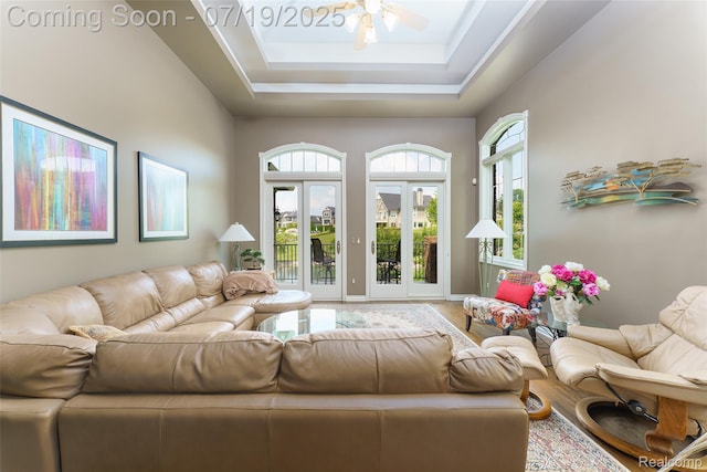 10827 Sparkling Waters Ct, South Lyon, MI 48178 - living room with wood finished floors, a ceiling fan, a tray ceiling, and a high ceiling
