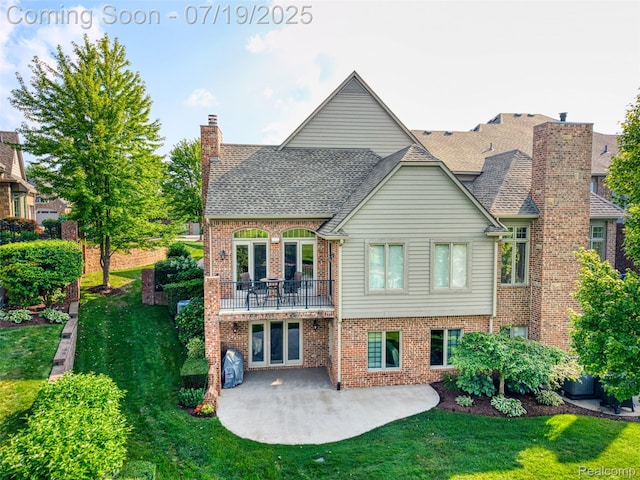 10827 Sparkling Waters Ct, South Lyon, MI 48178 - back of property featuring a patio, a shingled roof, brick siding, and a yard