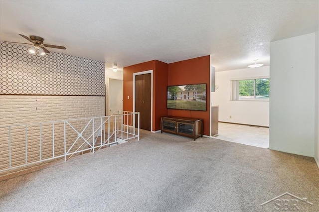 3118 Spruce St, Midland, MI 48640 - carpeted living area featuring a ceiling fan and a textured ceiling