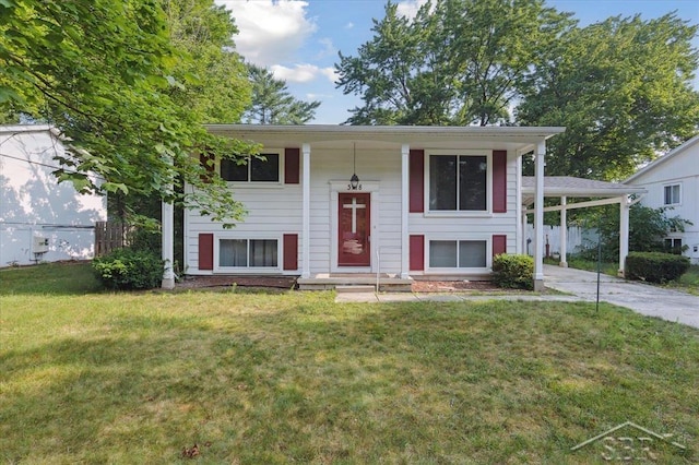 3118 Spruce St, Midland, MI 48640 - bi-level home with a front yard, concrete driveway, and a carport