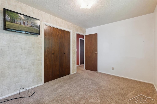 3118 Spruce St, Midland, MI 48640 - unfurnished bedroom with carpet floors, a closet, and a textured ceiling