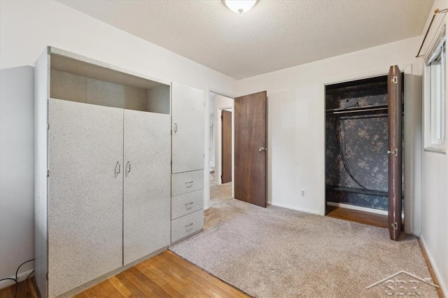 3118 Spruce St, Midland, MI 48640 - unfurnished bedroom with a closet, light wood-style floors, and a textured ceiling