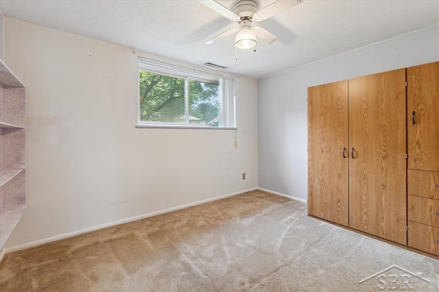 3118 Spruce St, Midland, MI 48640 - unfurnished bedroom with light colored carpet, ceiling fan, and a closet