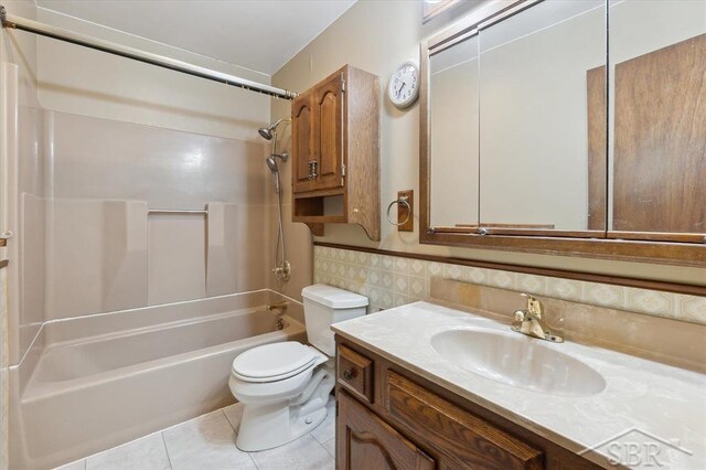 3118 Spruce St, Midland, MI 48640 - full bath featuring  shower combination, vanity, tile patterned floors, wainscoting, and tile walls