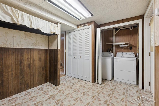 3118 Spruce St, Midland, MI 48640 - laundry area featuring wooden walls and washer and dryer