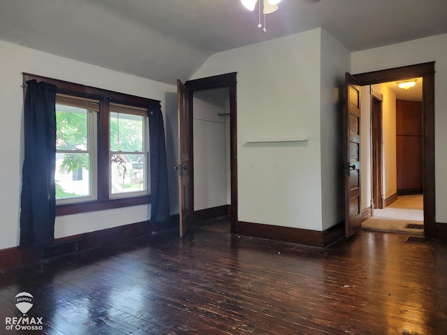 725 River St, Owosso, MI 48867 - unfurnished bedroom with hardwood / wood-style flooring, lofted ceiling, and a closet
