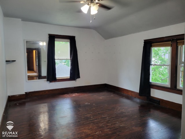 725 River St, Owosso, MI 48867 - empty room featuring a ceiling fan, healthy amount of natural light, lofted ceiling, and hardwood / wood-style flooring