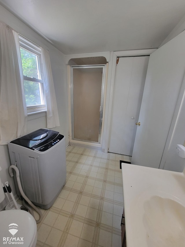 725 River St, Owosso, MI 48867 - bathroom with tile patterned floors, a stall shower, and vanity