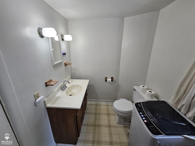 725 River St, Owosso, MI 48867 - bathroom featuring tile patterned floors, washer / clothes dryer, and vanity