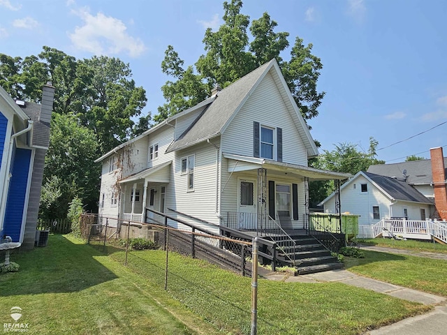 725 River St, Owosso, MI 48867 - view of front facade with a front yard and covered porch