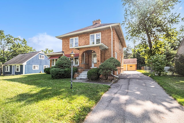 2551 Elmwood Ave, Ann Arbor, MI 48104 - view of front of house with brick siding, an outdoor structure, a chimney, and a garage