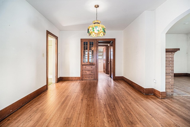 2551 Elmwood Ave, Ann Arbor, MI 48104 - unfurnished room featuring wood finished floors and arched walkways
