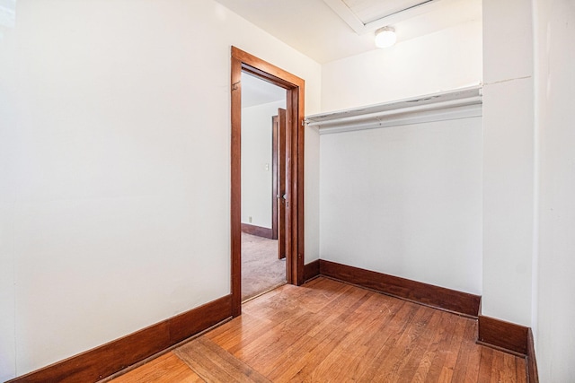 2551 Elmwood Ave, Ann Arbor, MI 48104 - unfurnished bedroom with a closet, light wood-style floors, and attic access
