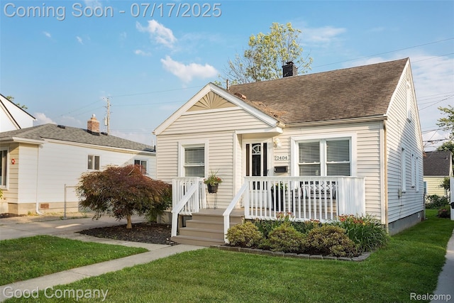 2404 Rowland Ave, Royal Oak, MI 48067 - view of front of house with a front yard, a chimney, a shingled roof, and covered porch