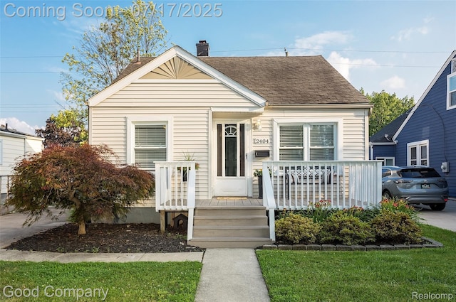 2404 Rowland Ave, Royal Oak, MI 48067 - view of front facade featuring a chimney, roof with shingles, and a porch
