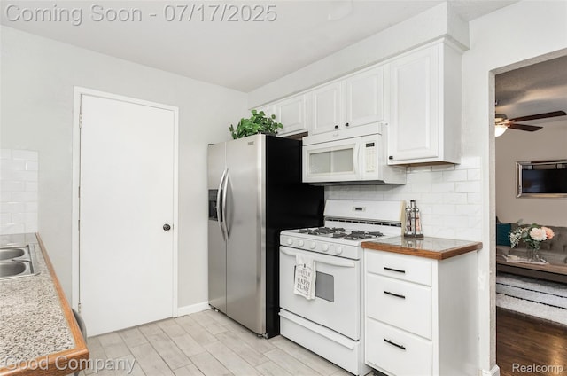2404 Rowland Ave, Royal Oak, MI 48067 - kitchen featuring white appliances, light wood-style floors, white cabinetry, tasteful backsplash, and a ceiling fan