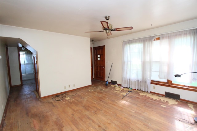 15439 Keegan Rd, Monroe, MI 48161 - empty room featuring wood finished floors, ceiling fan, and arched walkways