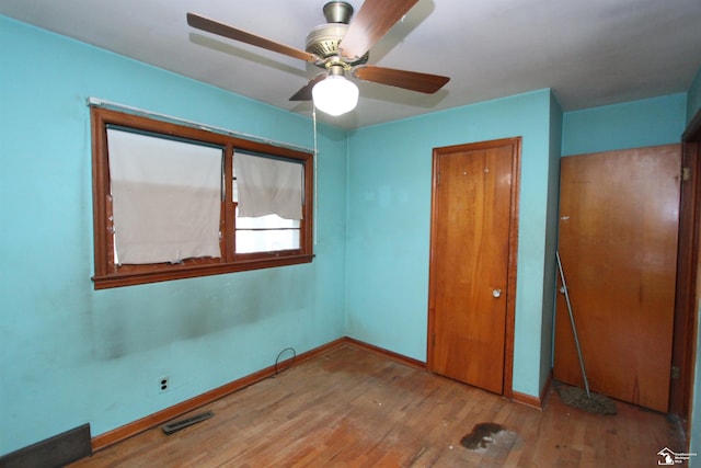 15439 Keegan Rd, Monroe, MI 48161 - unfurnished bedroom with wood finished floors, a closet, and a ceiling fan