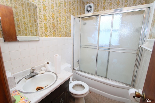 15439 Keegan Rd, Monroe, MI 48161 - full bathroom featuring wallpapered walls, vanity, tile walls, enclosed tub / shower combo, and wainscoting