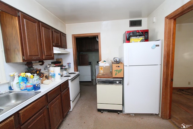 15439 Keegan Rd, Monroe, MI 48161 - kitchen with white appliances, washer and dryer, light countertops, and under cabinet range hood
