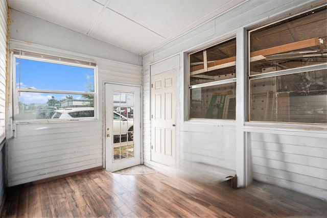 unfurnished sunroom featuring vaulted ceiling
