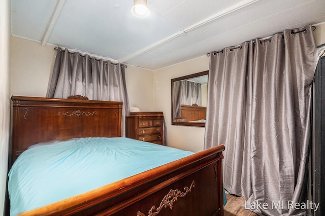 bedroom with wood finished floors