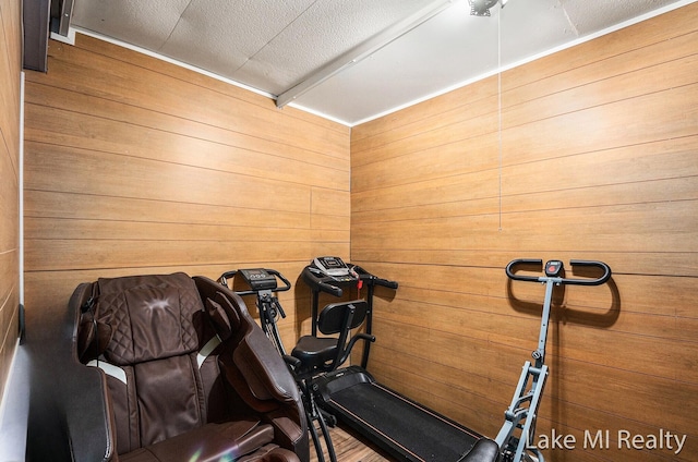 exercise room with wood walls
