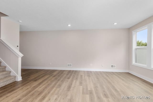 3349 Kings River St SW Unit 36, Wyoming, MI 49418 - unfurnished living room featuring light wood-style flooring, stairs, and recessed lighting