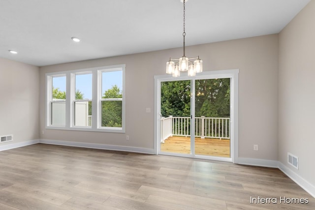 3349 Kings River St SW Unit 36, Wyoming, MI 49418 - spare room with a chandelier, light wood-type flooring, and recessed lighting
