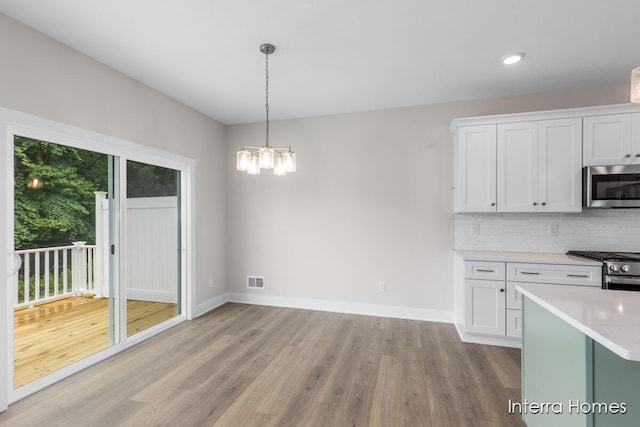 3349 Kings River St SW Unit 36, Wyoming, MI 49418 - kitchen featuring light wood-style floors, light countertops, white cabinets, stainless steel appliances, and recessed lighting
