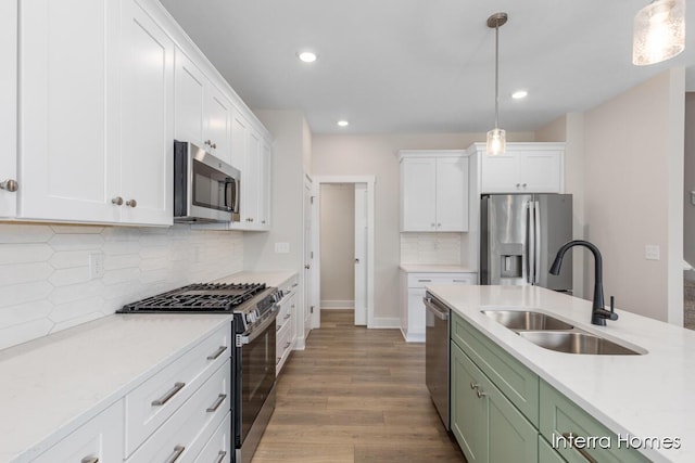 3349 Kings River St SW Unit 36, Wyoming, MI 49418 - kitchen featuring appliances with stainless steel finishes, white cabinetry, light countertops, green cabinetry, and recessed lighting