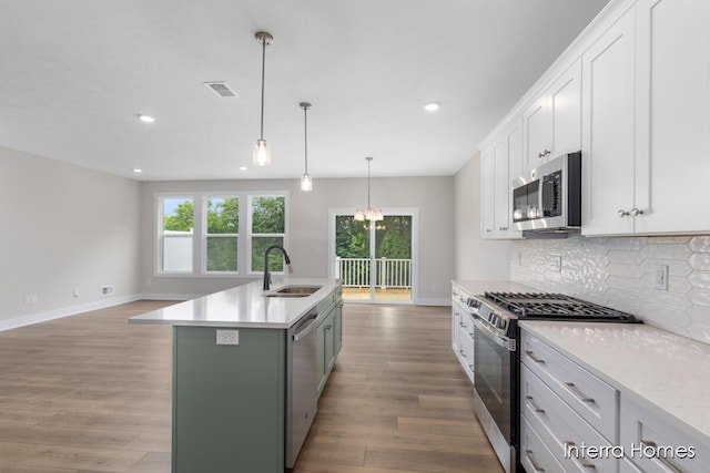 3349 Kings River St SW Unit 36, Wyoming, MI 49418 - kitchen featuring stainless steel appliances, recessed lighting, tasteful backsplash, light wood-type flooring, and healthy amount of natural light