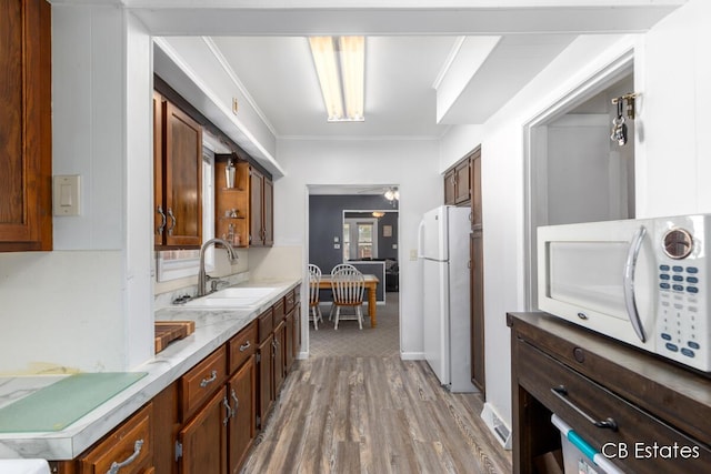 45 Murray St SW, Grand Rapids, MI 49548 - kitchen with white appliances, light wood-style flooring, and crown molding