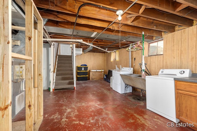 45 Murray St SW, Grand Rapids, MI 49548 - below grade area with washing machine and clothes dryer, wood walls, and stairway