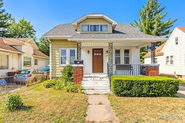 45 Murray St SW, Grand Rapids, MI 49548 - bungalow-style home featuring roof with shingles, a porch, board and batten siding, and a front lawn