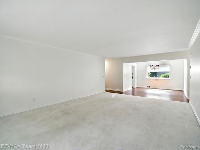 1711 Huntingwood Ln, Bloomfield Hills, MI 48304 - carpeted spare room featuring ornamental molding and a chandelier