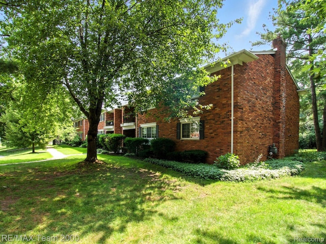 1711 Huntingwood Ln, Bloomfield Hills, MI 48304 - view of home's exterior with brick siding, a chimney, and a lawn