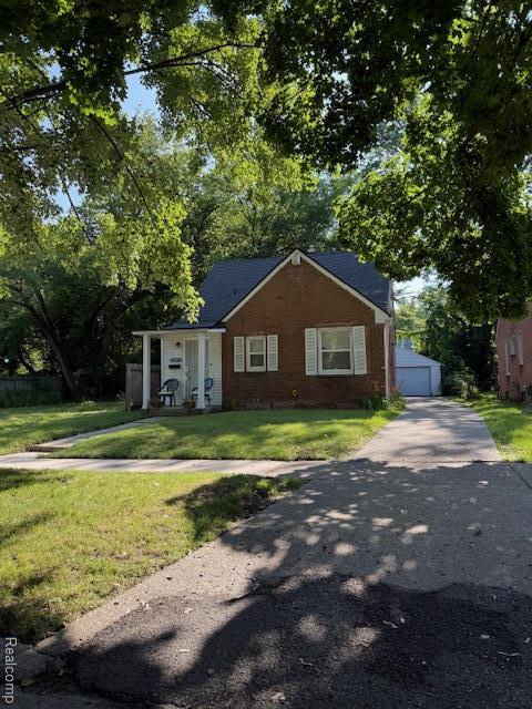 17126 Patton St, Detroit, MI 48219 - view of front of home with a front lawn, an outbuilding, and a garage